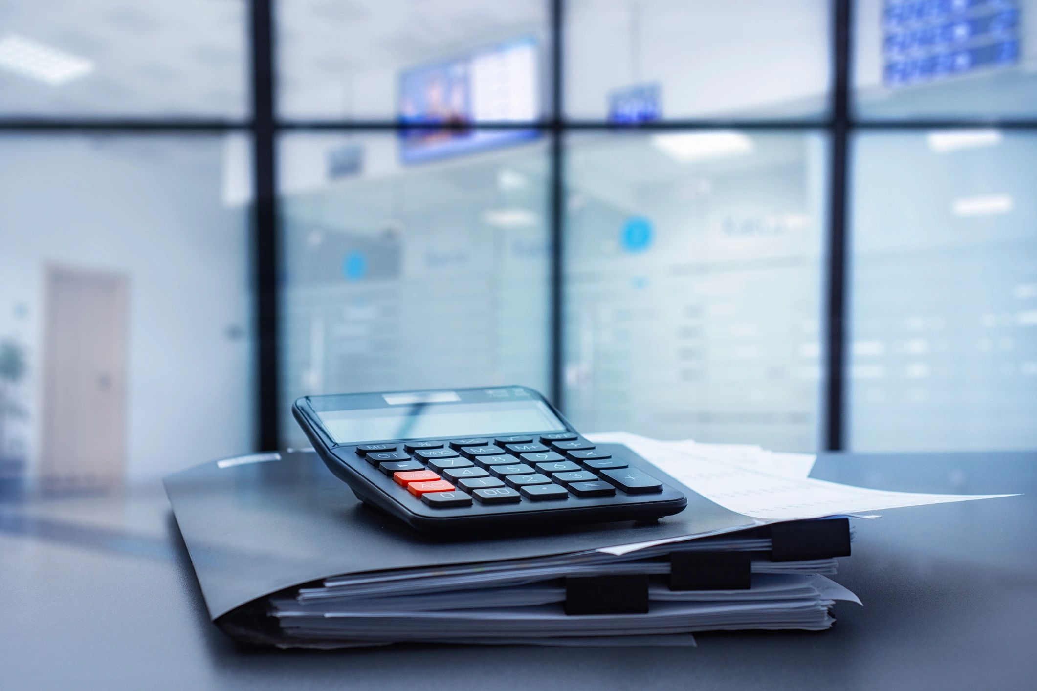 Financial analysis documents and calculator representing valuation and underwriting