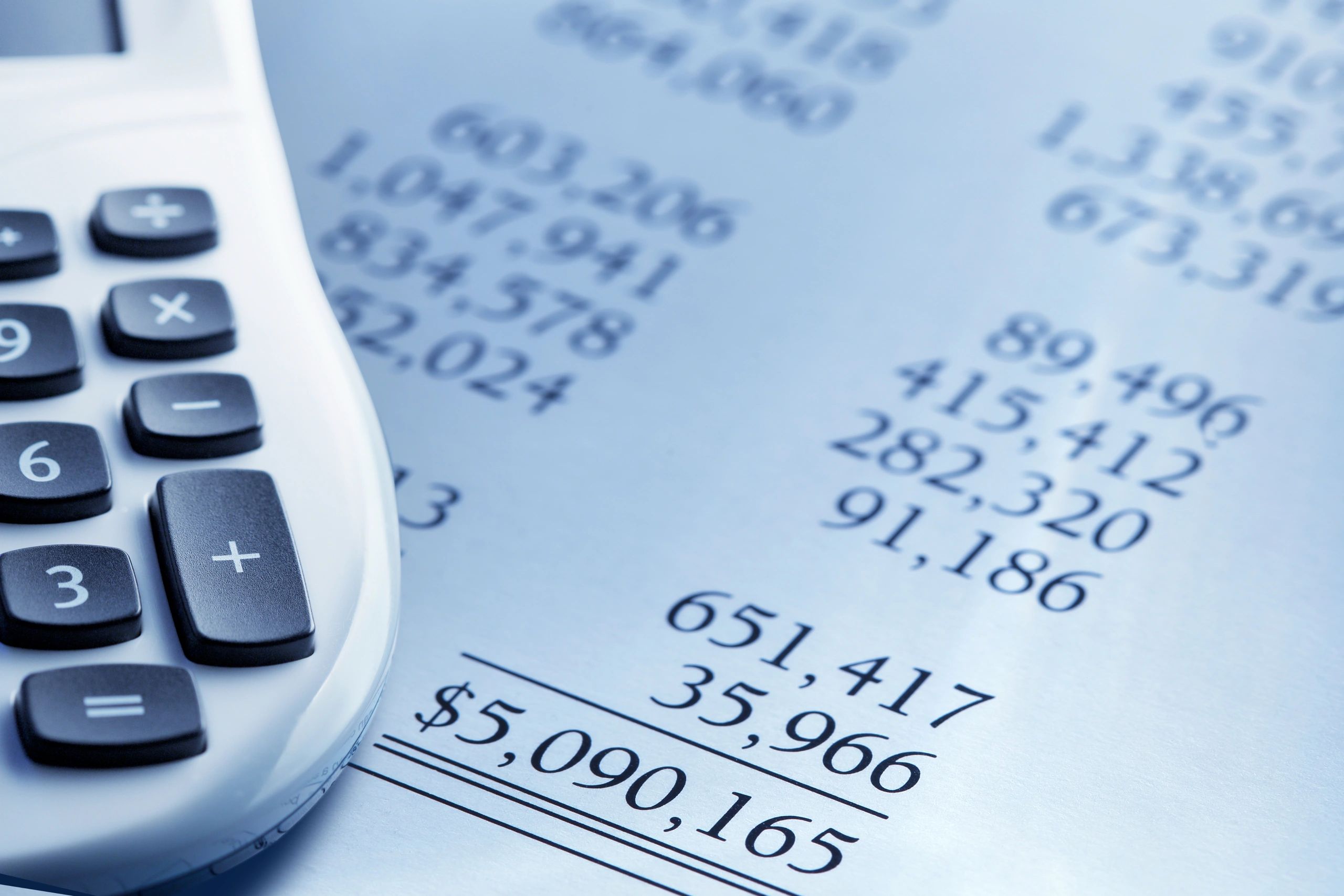 Calculator resting on a financial report, representing valuation analysis